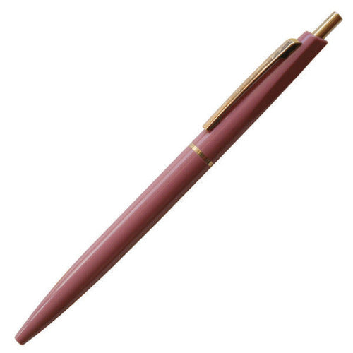 Mauve pen with gold accents on a white background